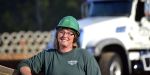 A woman CDL driver smiles on site of her Georgia road job