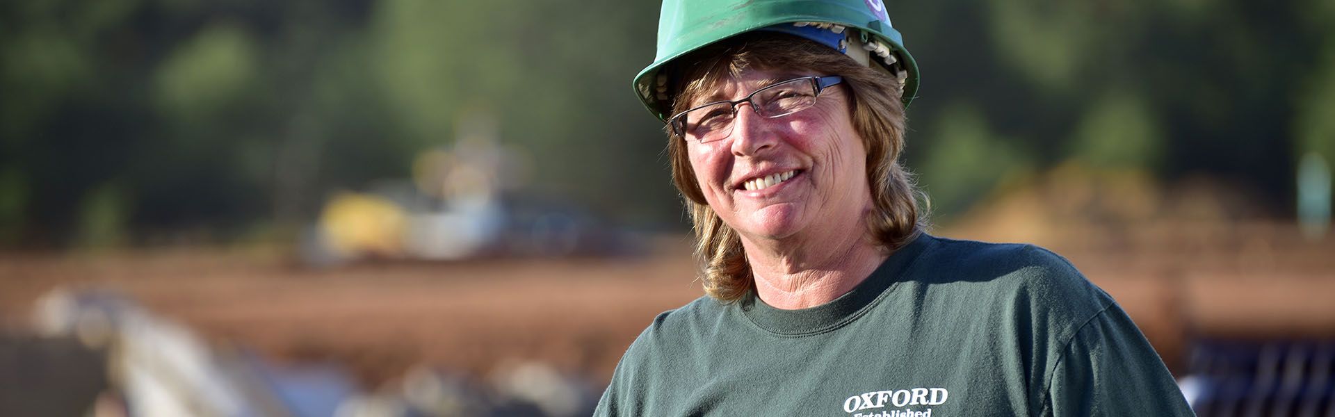 A female CDL driver smiles while on site of her road construction job in Georgia