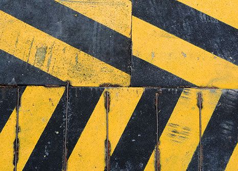 collage of yellow and black street lines painted by road construction laborers in Georgia