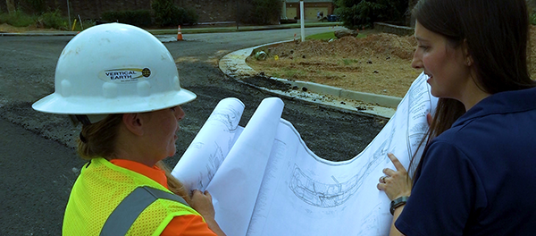 Two female highway construction workers reviewing a blue print for road construction job in Georgia