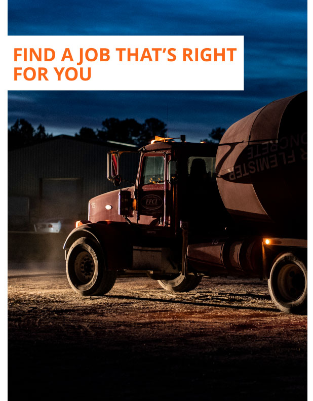 A concrete truck, used by contractors who have available road construction jobs, is about to go out to a road construction site  in the early morning