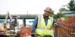 Luis Cervantes smiles on a construction site because he loves his Georgia construction career.