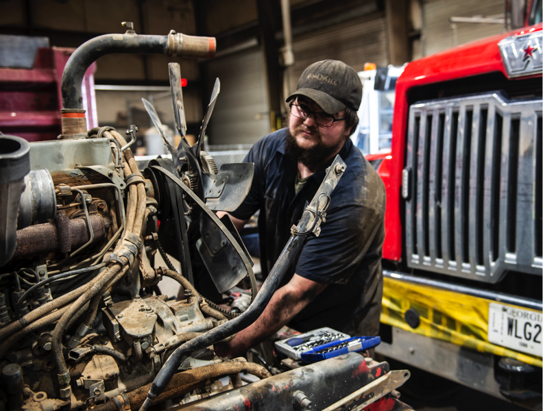 A heavy equipment mechanic smiles thinking about the success he has had in his road construction career