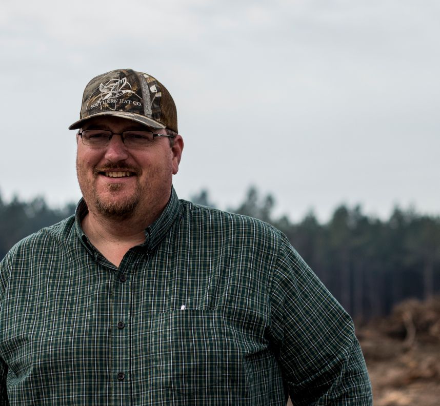 A highway construction foreman smiles on site of his construction career in Georgia