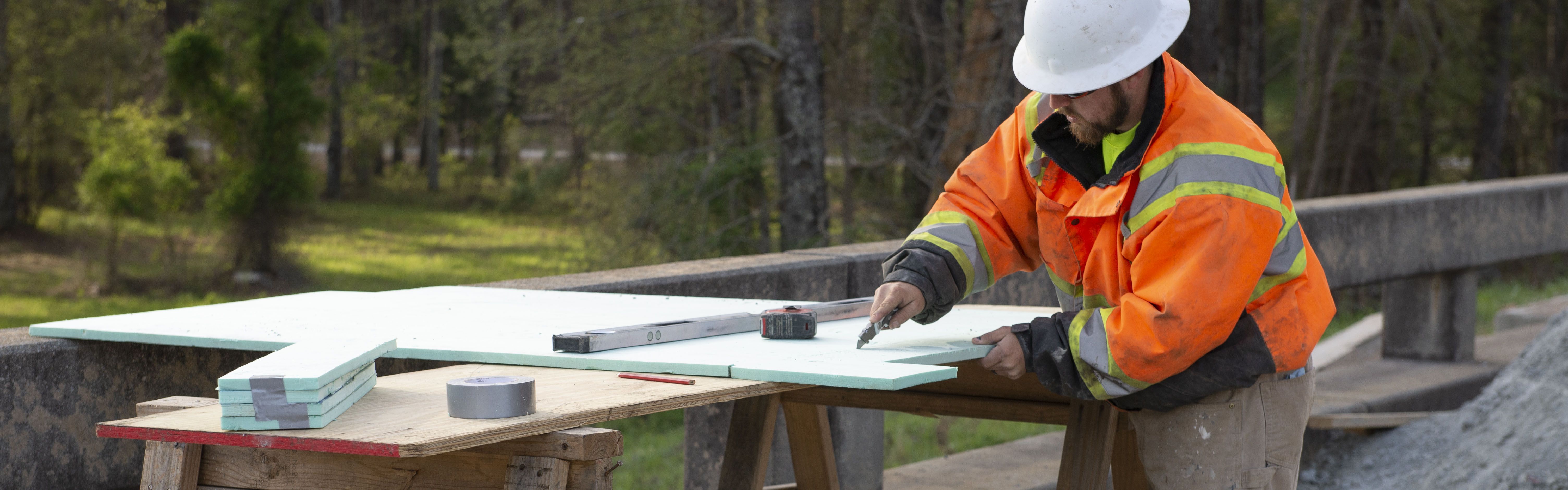 A bridge carpenter works on a project on site of his road construction career in Georgia 