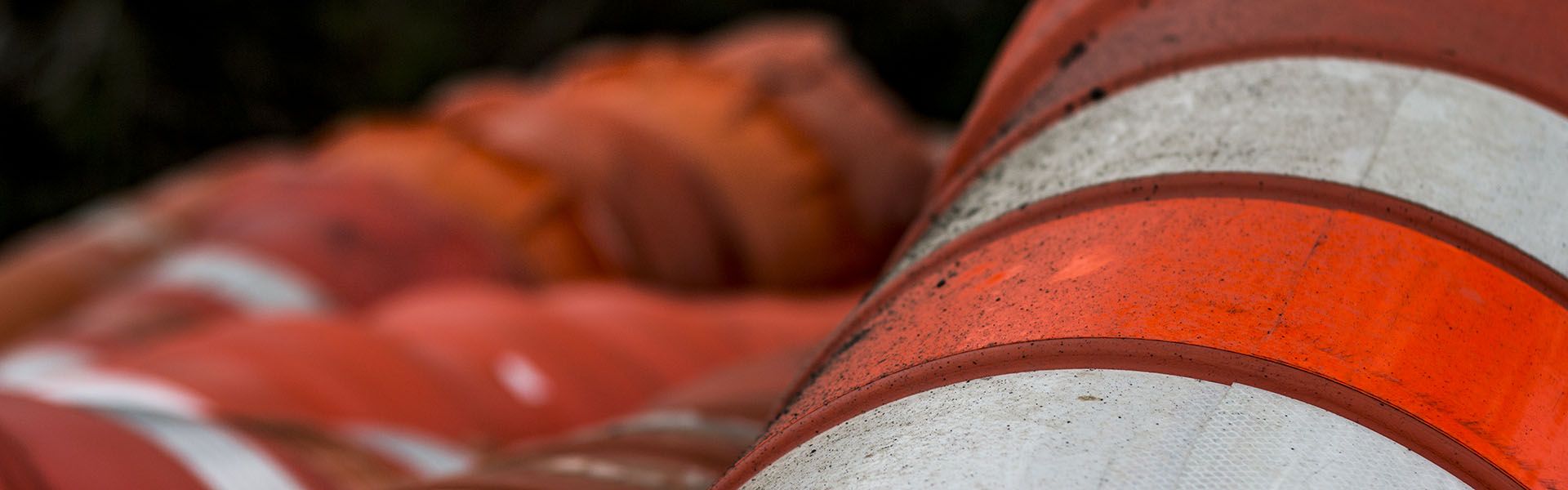 Several orange construction cones wait to be brought to a Georgia road construction job site