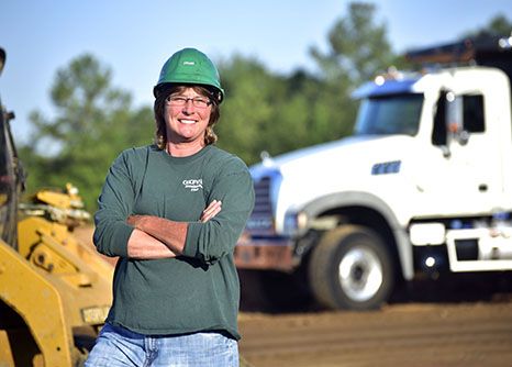 A female CDL driver who works for a road construction company in Georgia