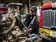 A heavy equipment mechanic smiles on site of his Georgia road job 