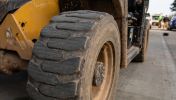 A close up of a tire on a piece of heavy equipment machinery used by road construction workers in Georgia