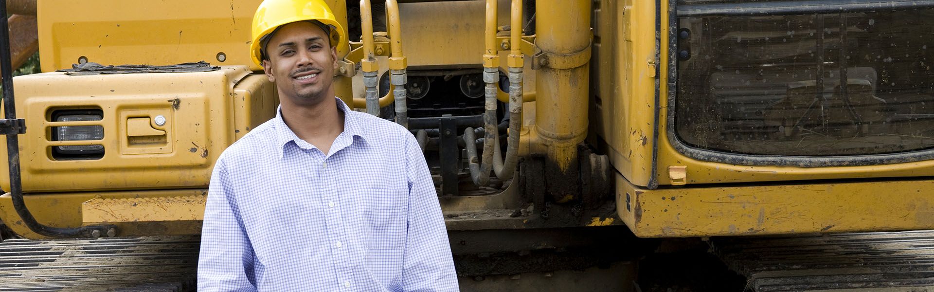A heavy equipment operator smiles on site of his highway construction career in Georgia