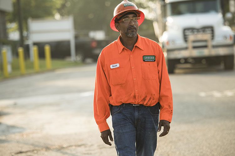 Emmitt Hall, a highway construction worker, wears a orange shirt on site of his road job in Georgia