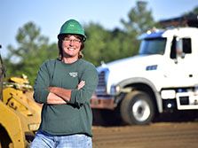 A female truck driver/CDL driver smiles during her road construction career in Georgia