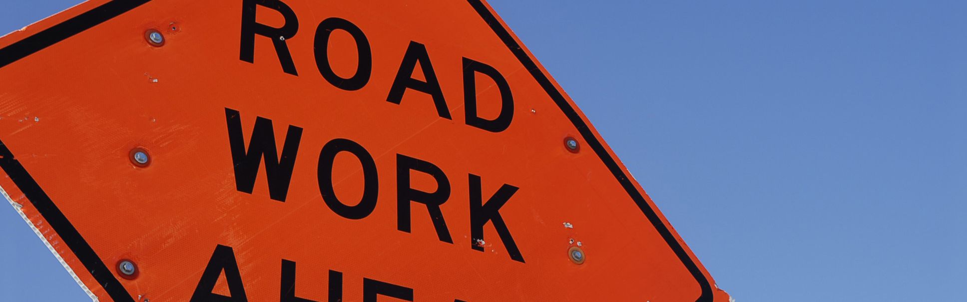 Orange construction sign that says Road Work Ahead on site at a Georgia construction career
