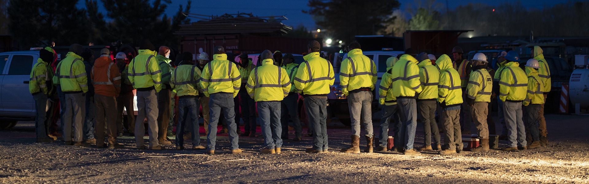Road construction workers lined up on site wearing yellow attire in their Georgia construction careers