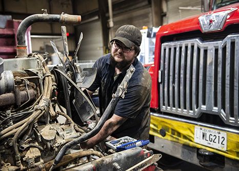 A heavy equipment mechanic smiles on site of his road construction career in Georgia